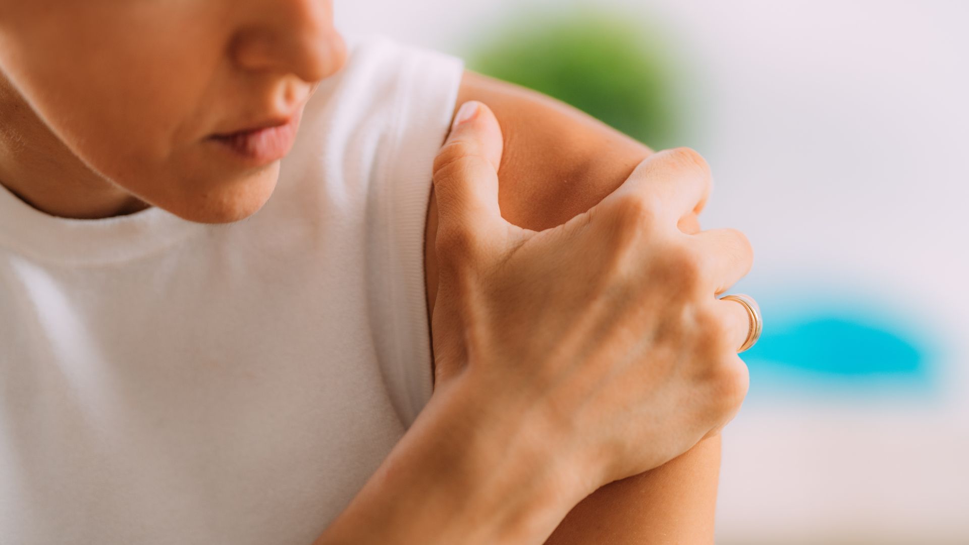 A close up of a person holding their arm